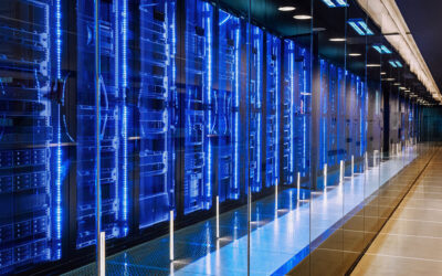 A modern data center with rows of illuminated blue server racks lining a sleek corridor, representing the advanced technology powering AI development.