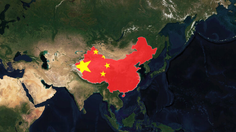 A satellite map highlighting China with its territory filled in red and adorned with five large yellow stars, mimicking the design of the Chinese national flag, set against a detailed view of Asia and surrounding regions.
