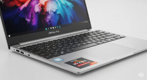 Aluminum Aim Max Plus laptop open on desk showing display and keyboard.